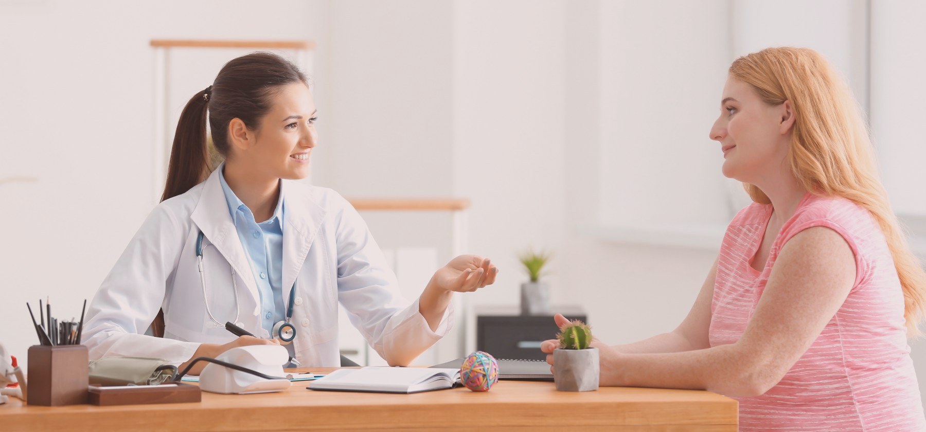 A woman engaging in a consultation with a doctor