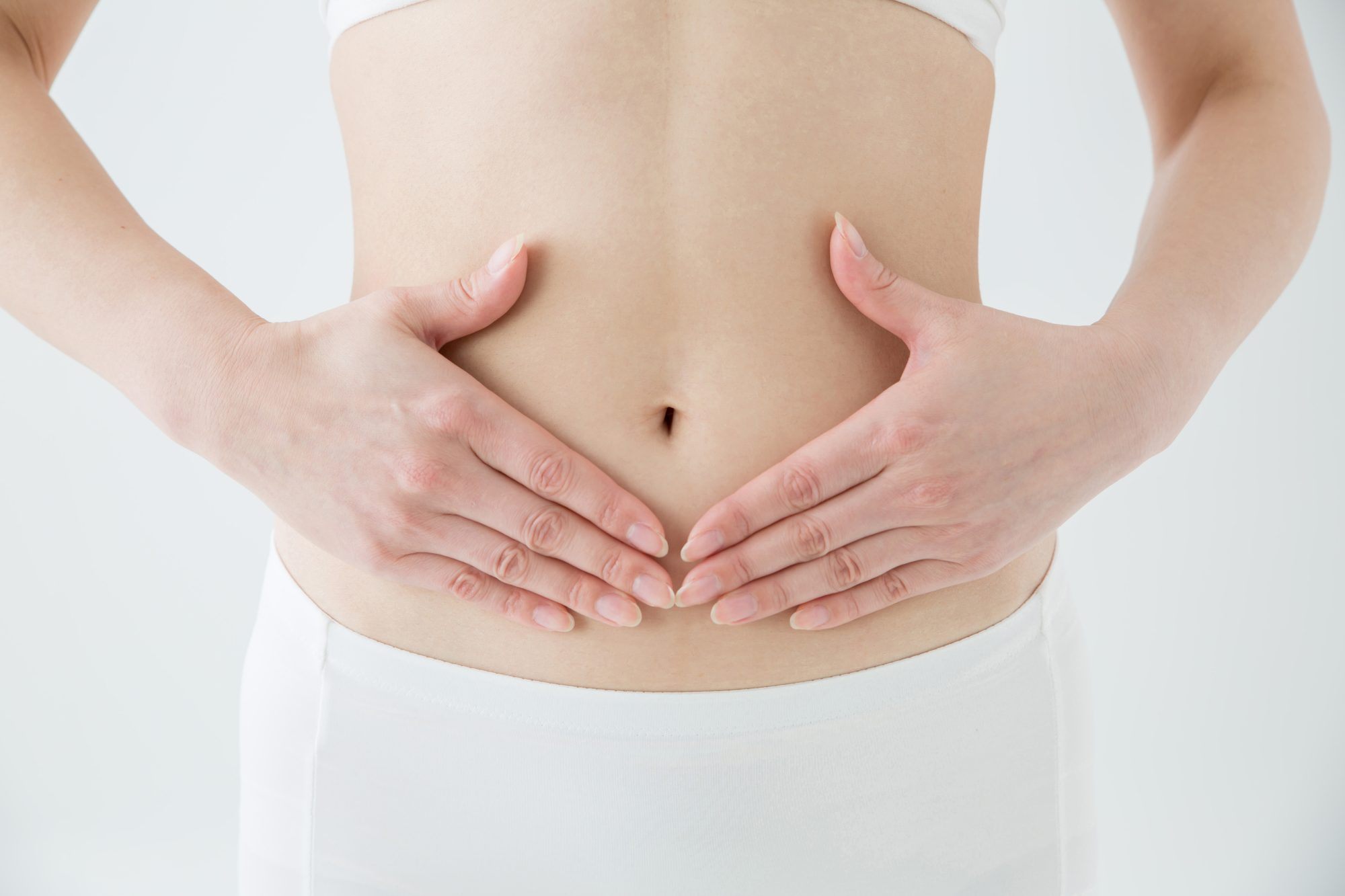 A Woman cradling her abdomen in her hands